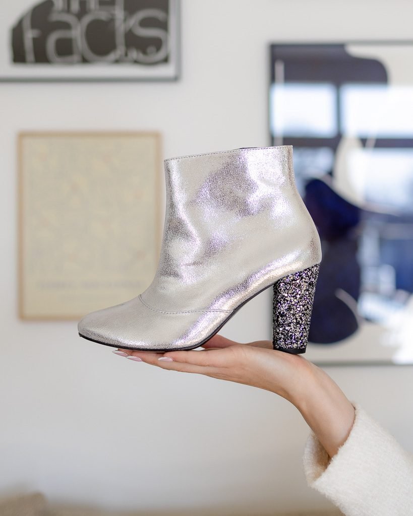 Heeled bootie in iridescent silver leather and glitter chrome.